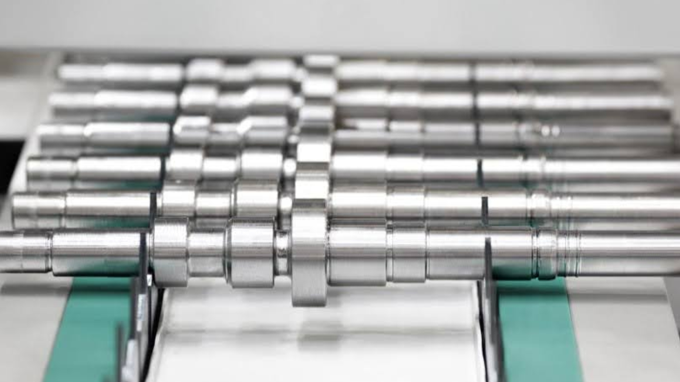 Precision dowel pins of varying sizes arranged on a machinist's inspection table in Singapore